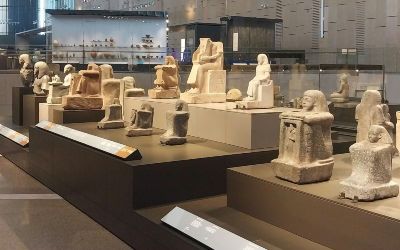 Ancient Egyptian artifacts displayed in a gallery at the Grand Egyptian Museum