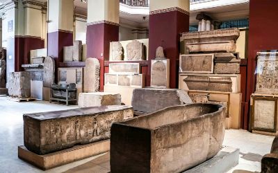 Stone sarcophagi and funerary objects exhibited in the Grand Egyptian Museum