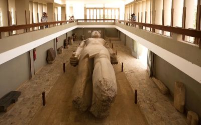 Colossal limestone statue of Ramses II displayed in the Memphis open-air museum
