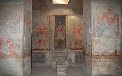 Wall paintings inside an Old Kingdom noble tomb in Saqqara featuring ancient Egyptian figures